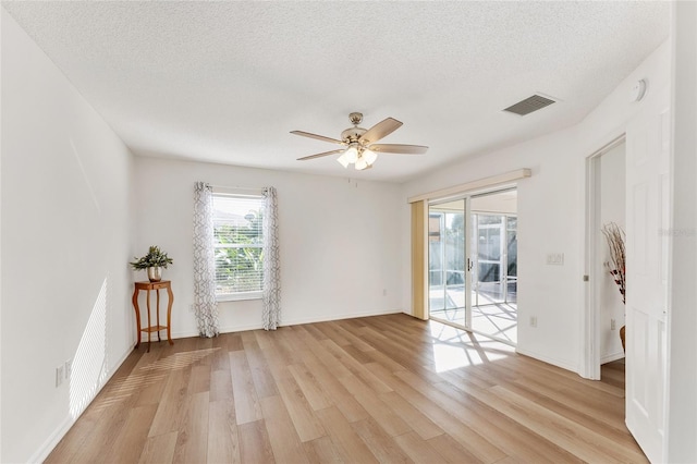 unfurnished room featuring ceiling fan, a textured ceiling, and light hardwood / wood-style flooring