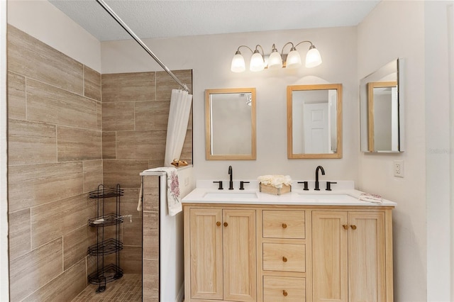 bathroom featuring vanity, a shower with curtain, and a textured ceiling