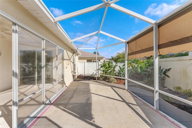 unfurnished sunroom featuring a healthy amount of sunlight and lofted ceiling