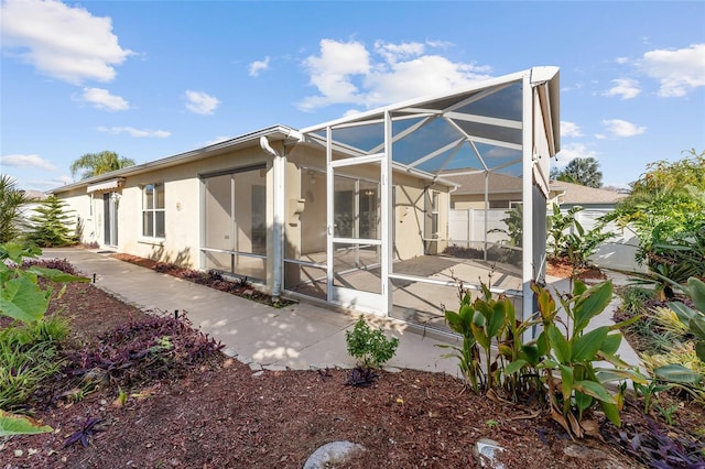 back of property with a lanai