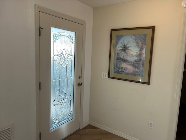 entryway with hardwood / wood-style flooring