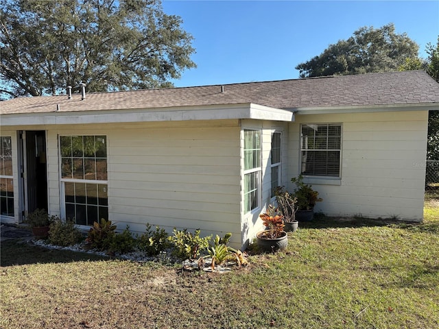 view of side of home featuring a lawn