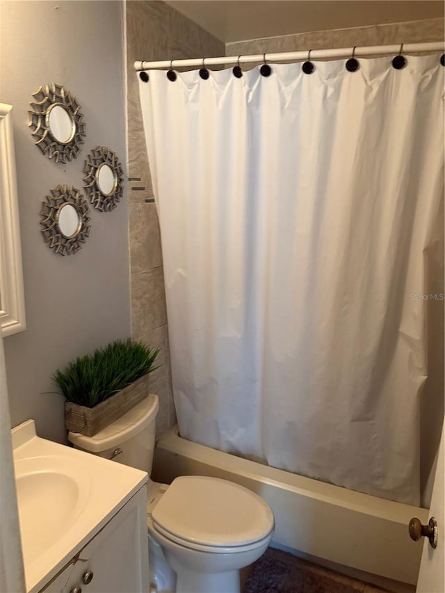 full bathroom featuring toilet, vanity, and shower / tub combo