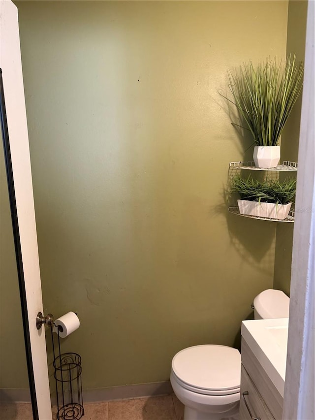 bathroom featuring vanity, toilet, and tile patterned floors