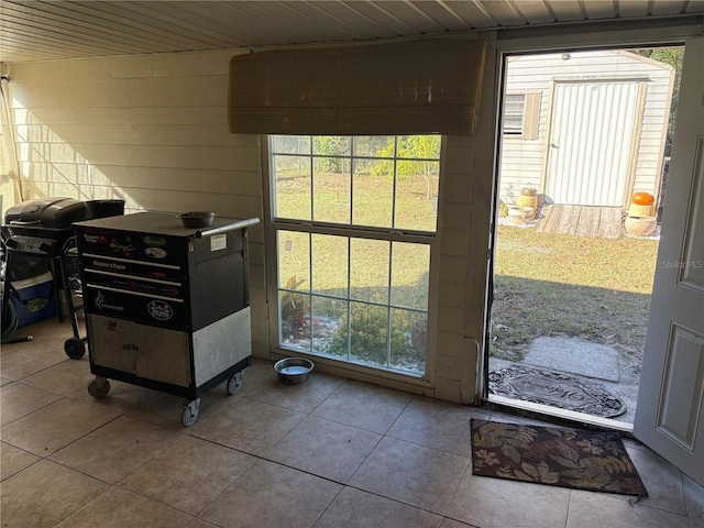 doorway to outside with light tile patterned floors