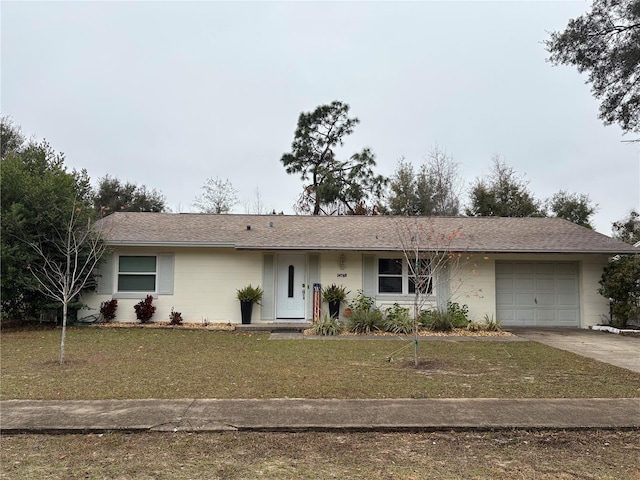 single story home with a front yard and a garage