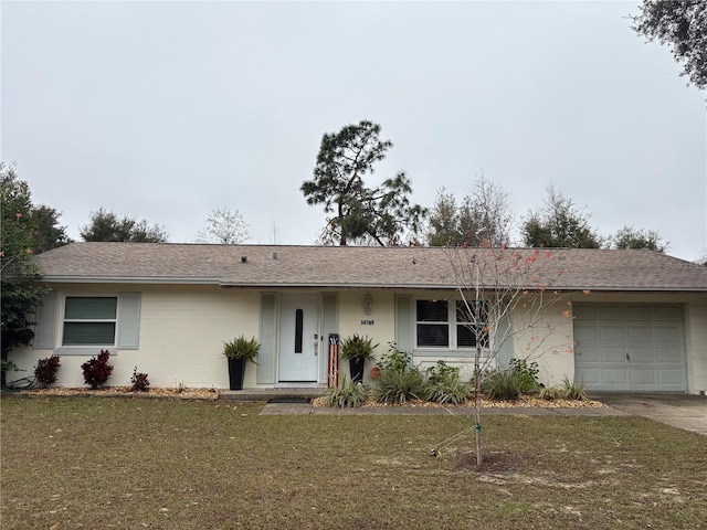 ranch-style house featuring a garage and a front yard