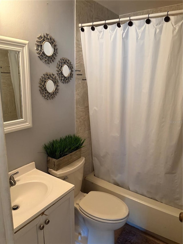 full bathroom featuring vanity, toilet, and shower / bathtub combination with curtain