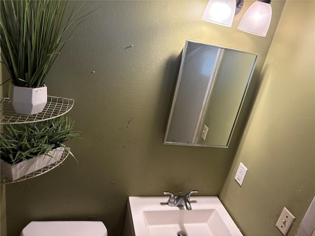 bathroom featuring sink and toilet