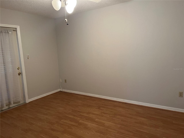 unfurnished room with hardwood / wood-style flooring, ceiling fan, and a textured ceiling