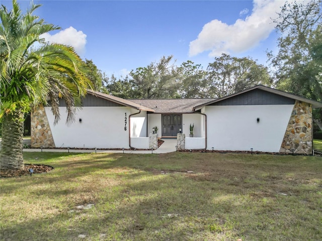 rear view of house with a yard