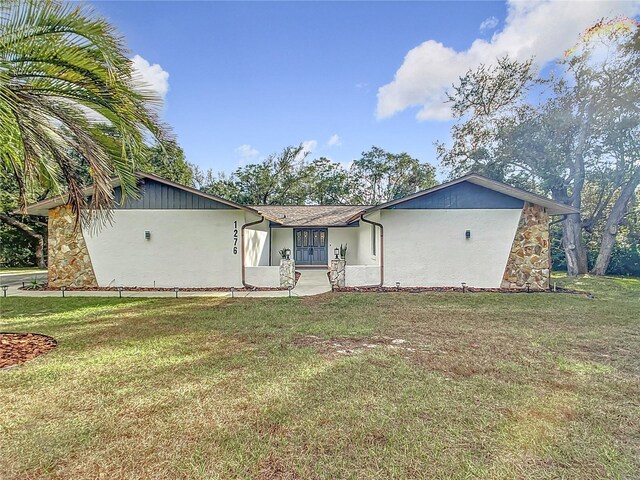 rear view of house with a yard