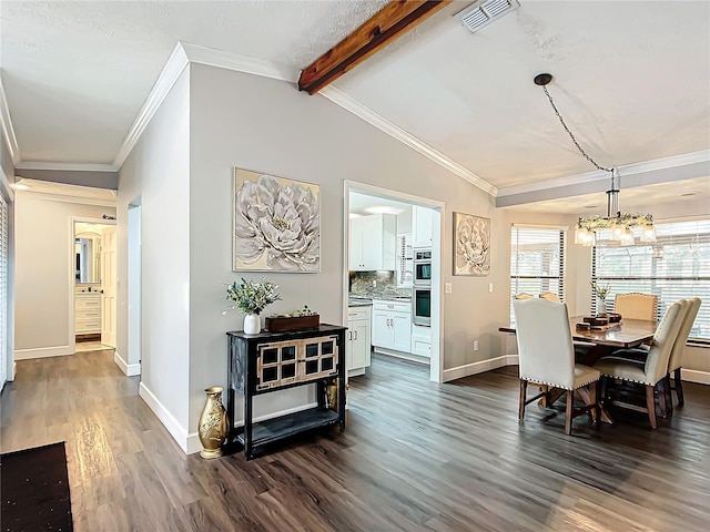 dining room featuring vaulted ceiling with beams, dark hardwood / wood-style floors, an inviting chandelier, and crown molding