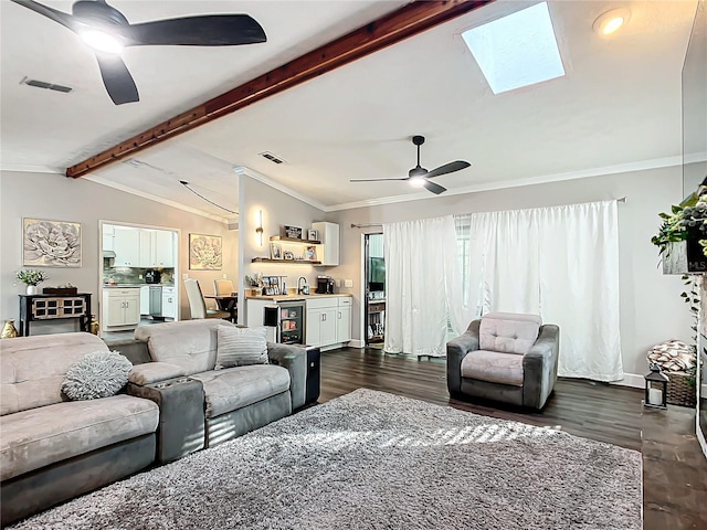 living room featuring vaulted ceiling with skylight, ceiling fan, sink, dark hardwood / wood-style floors, and wine cooler