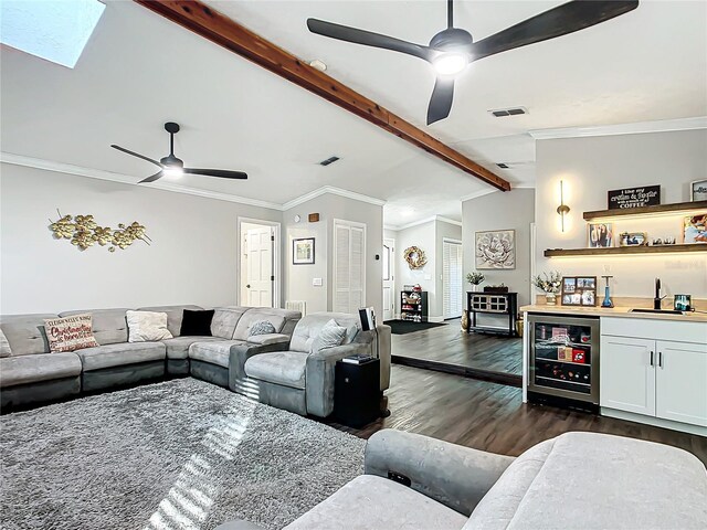 living room with lofted ceiling with beams, dark hardwood / wood-style floors, ornamental molding, indoor wet bar, and beverage cooler