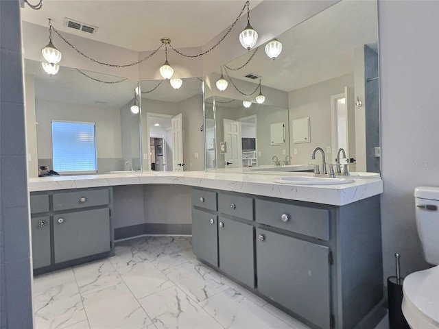 bathroom featuring vanity and toilet