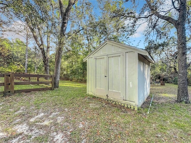 view of outbuilding with a yard