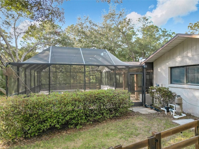 view of yard with glass enclosure