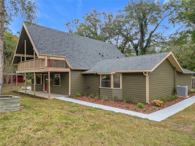 view of front of home featuring a patio area, a wooden deck, central AC unit, and a front yard