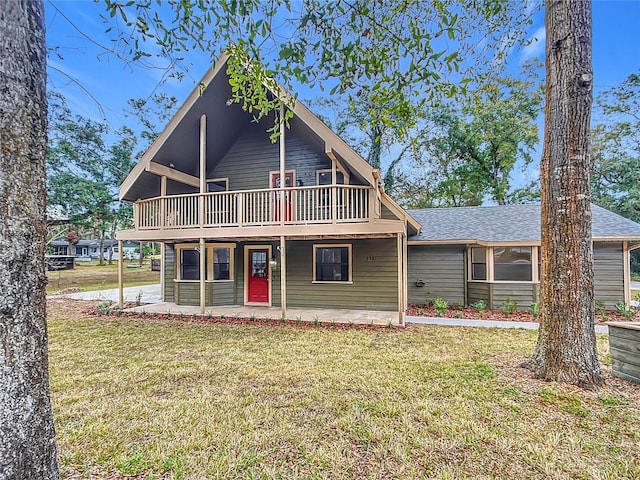 view of front of house with a front yard, a patio, and a deck