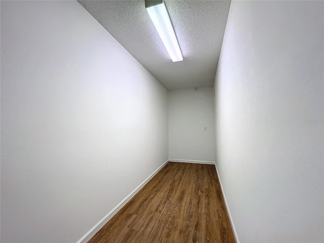 empty room featuring hardwood / wood-style floors and a textured ceiling