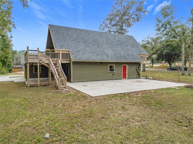 back of property with a yard, a patio, and a wooden deck