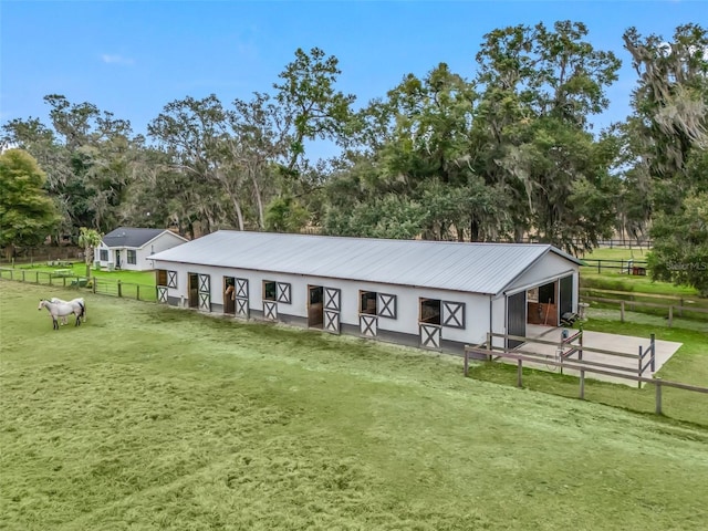 view of front of house with a rural view and an outdoor structure