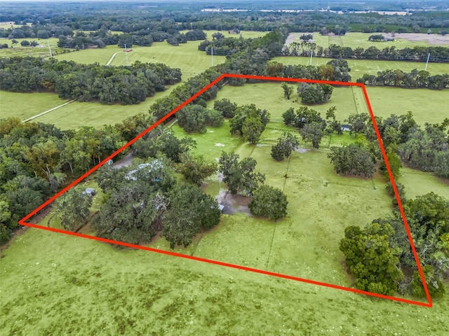 birds eye view of property with a rural view