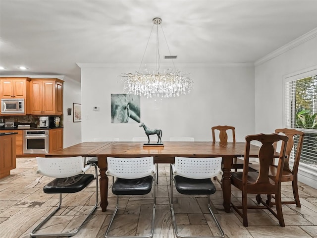 dining area featuring a chandelier and ornamental molding