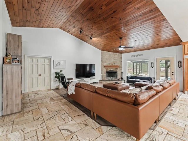 living room featuring a stone fireplace, ceiling fan, high vaulted ceiling, and wood ceiling