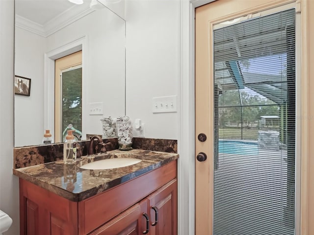 bathroom with vanity and ornamental molding