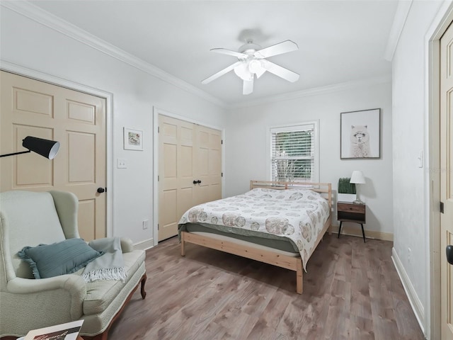 bedroom featuring ceiling fan, light hardwood / wood-style floors, and ornamental molding