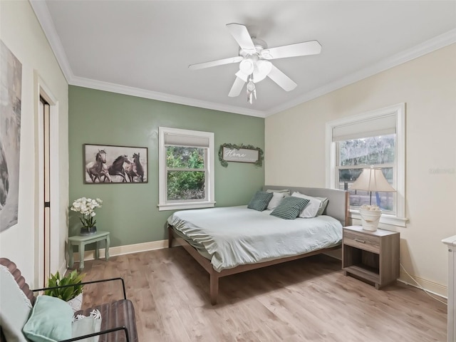 bedroom featuring light hardwood / wood-style flooring, ceiling fan, and ornamental molding