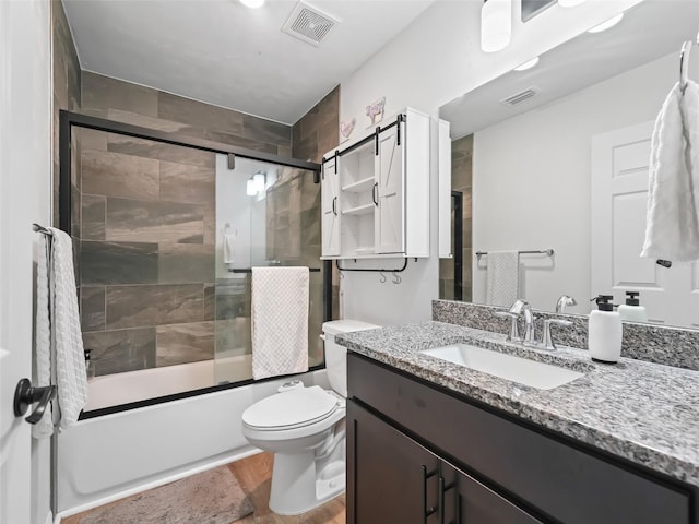 full bathroom with vanity, toilet, and combined bath / shower with glass door