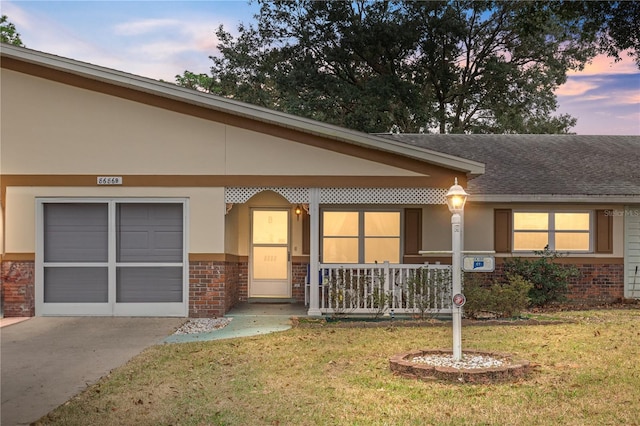 view of front of property with a lawn and a porch