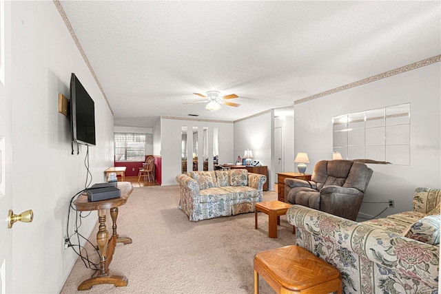 carpeted living room with ceiling fan, crown molding, and a textured ceiling