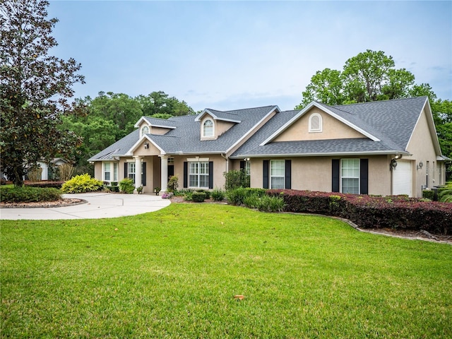 view of front of property with a garage and a front yard