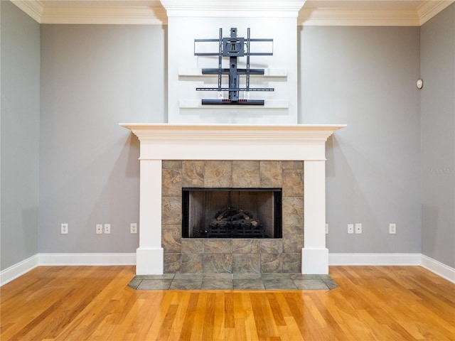 room details featuring a fireplace, hardwood / wood-style floors, and ornamental molding