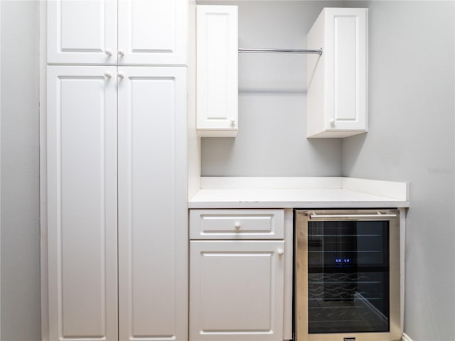 bar with white cabinets and wine cooler