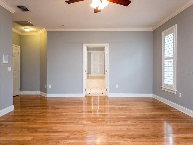 spare room featuring ceiling fan, light hardwood / wood-style floors, and ornamental molding