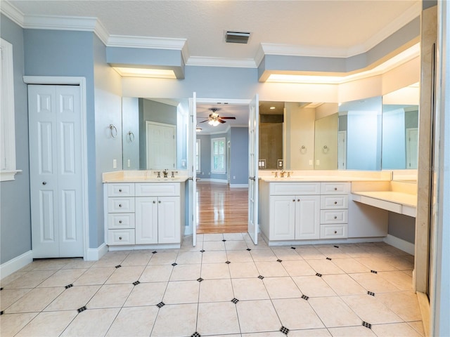 bathroom featuring ceiling fan, ornamental molding, and vanity