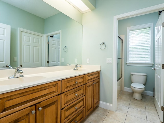 full bathroom with tile patterned flooring, vanity, toilet, and enclosed tub / shower combo