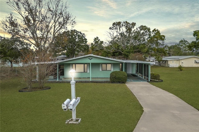 single story home with a yard and a carport