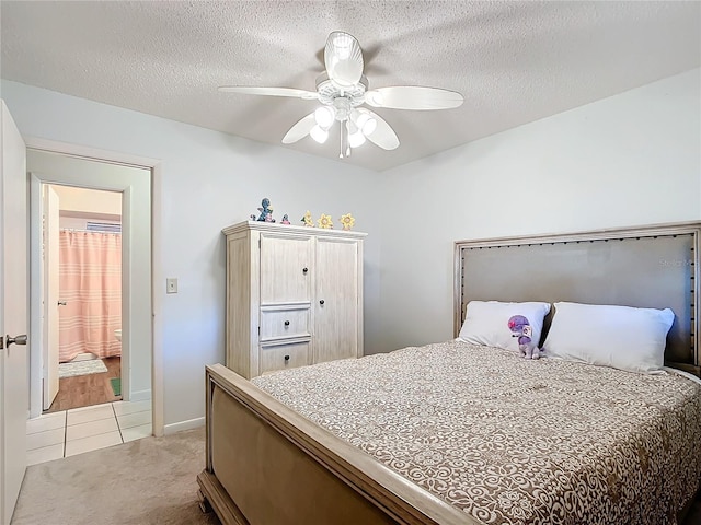 bedroom with light carpet, a textured ceiling, and ceiling fan