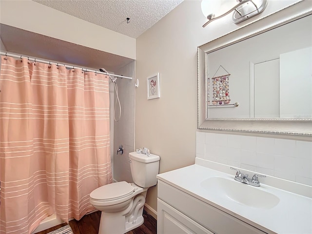 bathroom featuring tasteful backsplash, a shower with curtain, a textured ceiling, toilet, and vanity