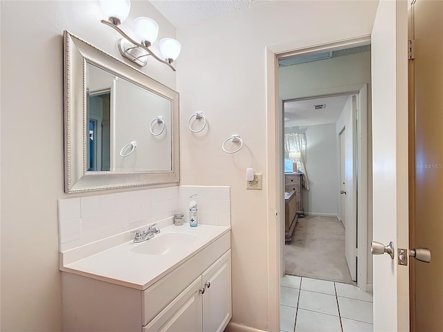 bathroom with tile patterned floors, vanity, and a textured ceiling