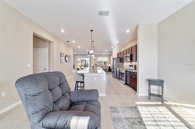 living room featuring light tile patterned floors and sink