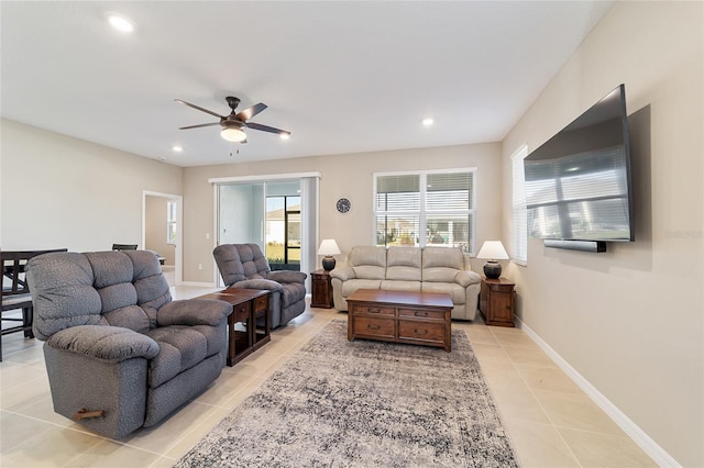 living room with ceiling fan and light tile patterned floors