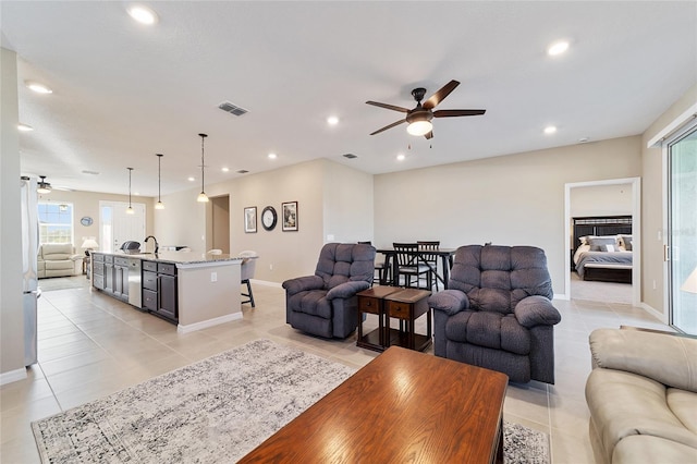 living room featuring ceiling fan and light tile patterned flooring