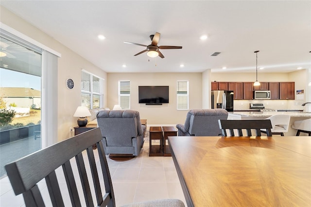 dining room with ceiling fan and light tile patterned flooring